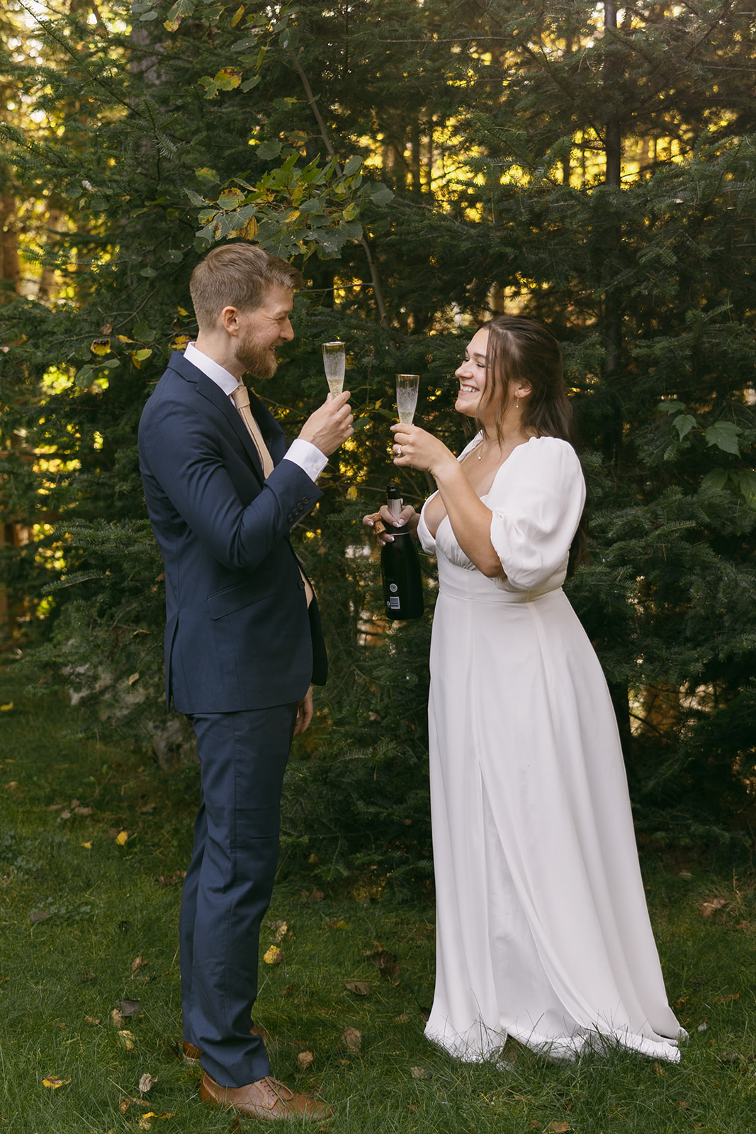 bride and groom share champagne on their stunning elopement