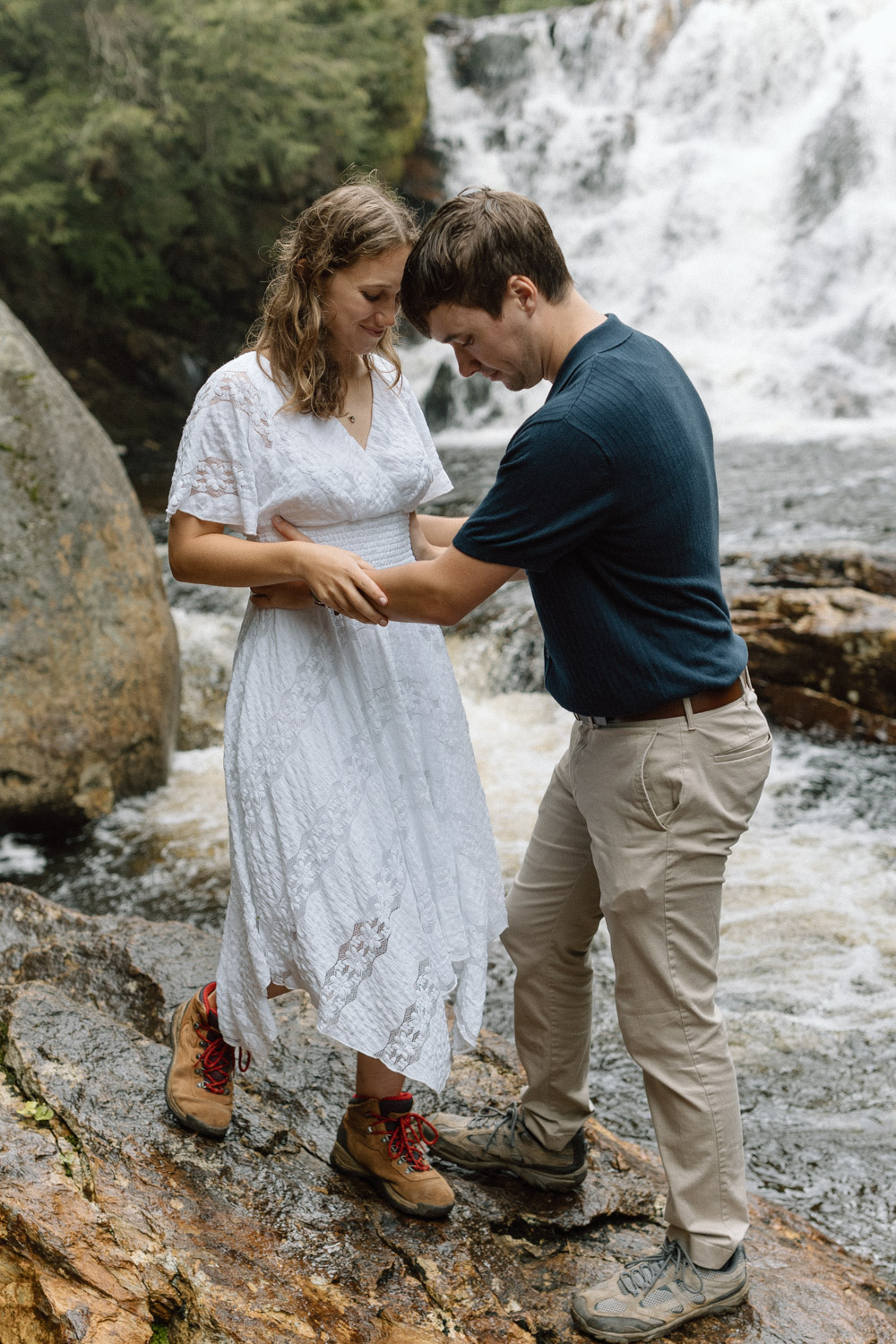 Bride and groom in front of beautiful waterfall in New Hampshire 