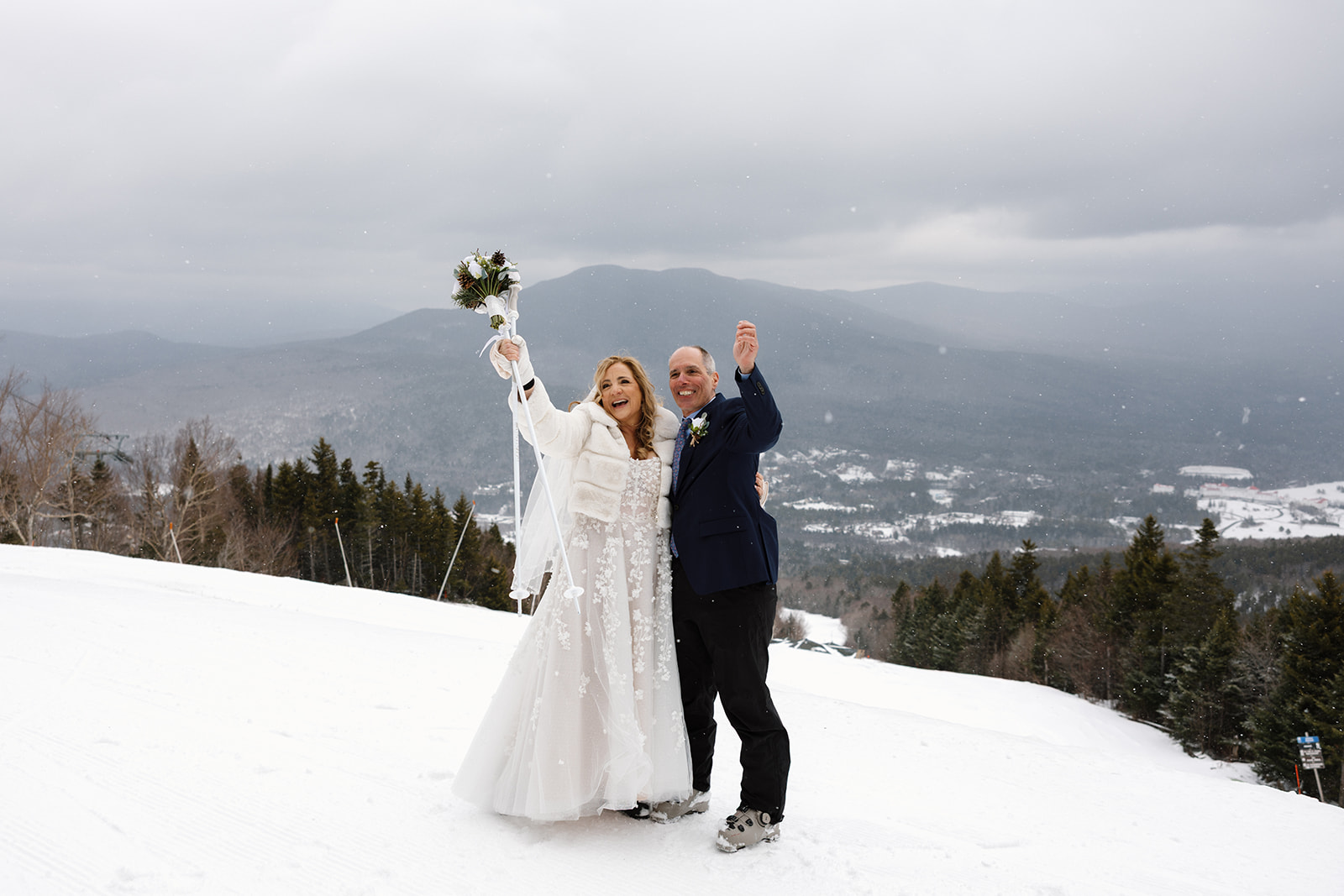 Couple stands on top of a mountain in the White Mountains of New Hampshire at their winter ski elopement