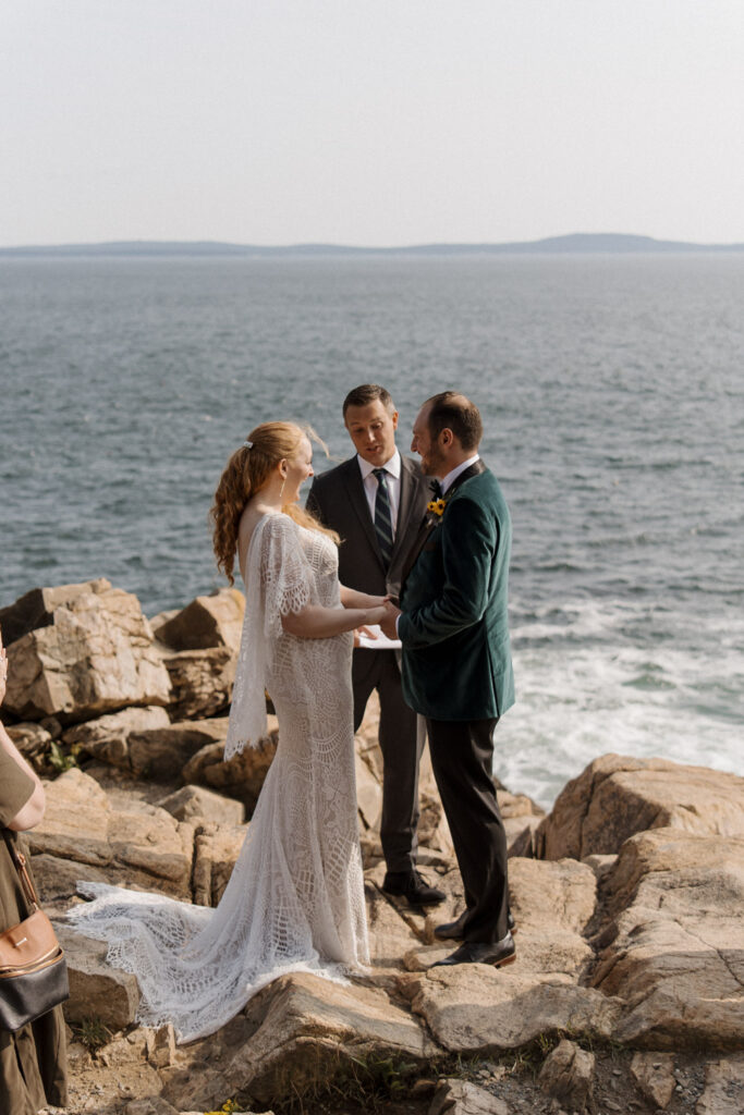 Couple saying vows at Otter Cliffs in Acadia National Park