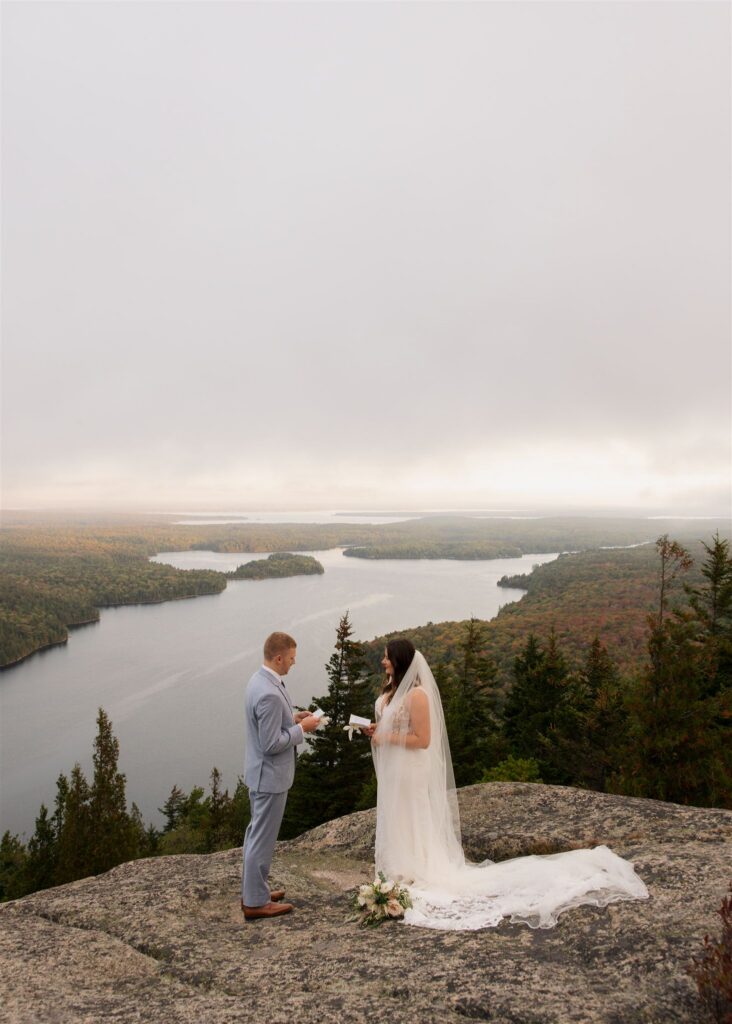Couple saying vows at sunrise in Acadia National Park