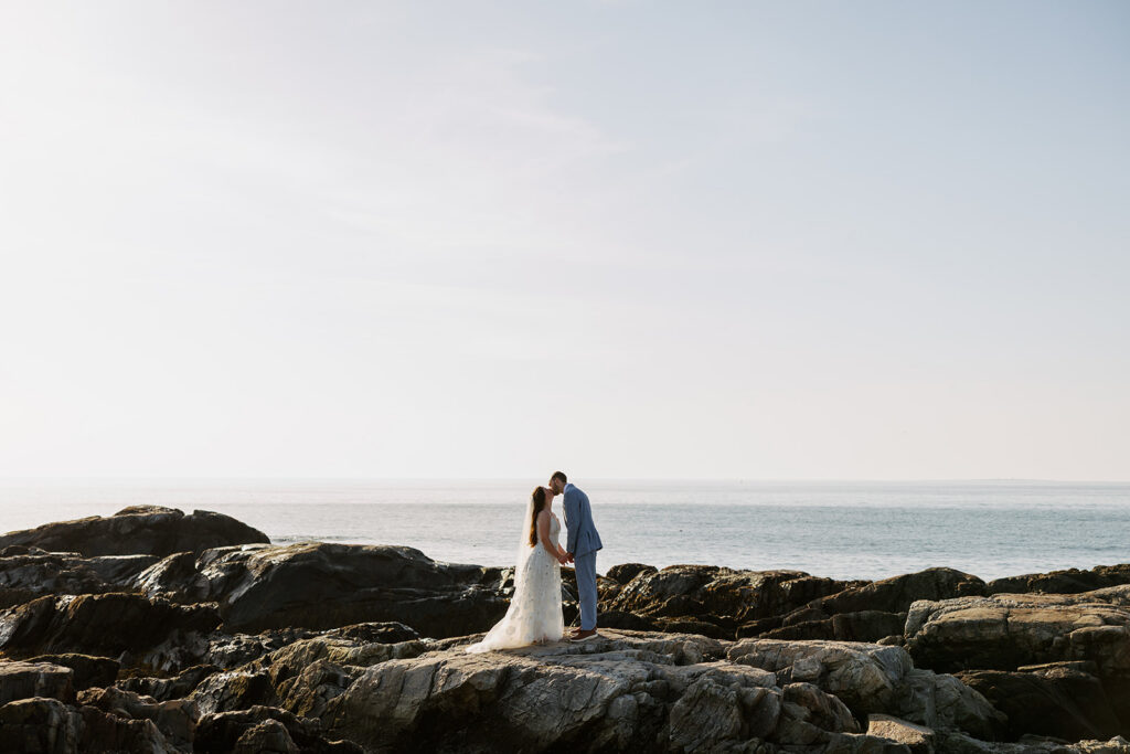 Bride and groom on the rocks at Wallis Sands in Rye, New Hampshire