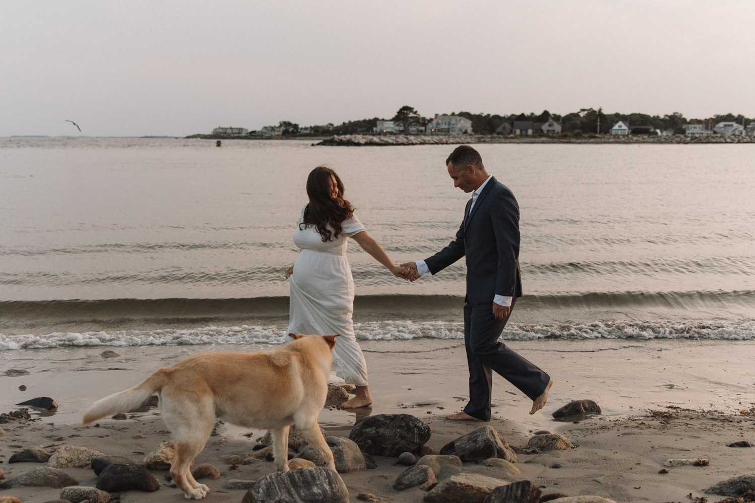 couple holding hands during their rye harbor state park elopement.