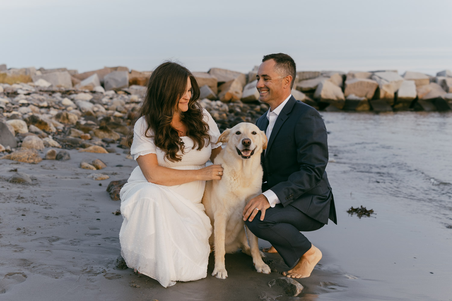 couple posing during their rye harbor state park elopement with their dog.