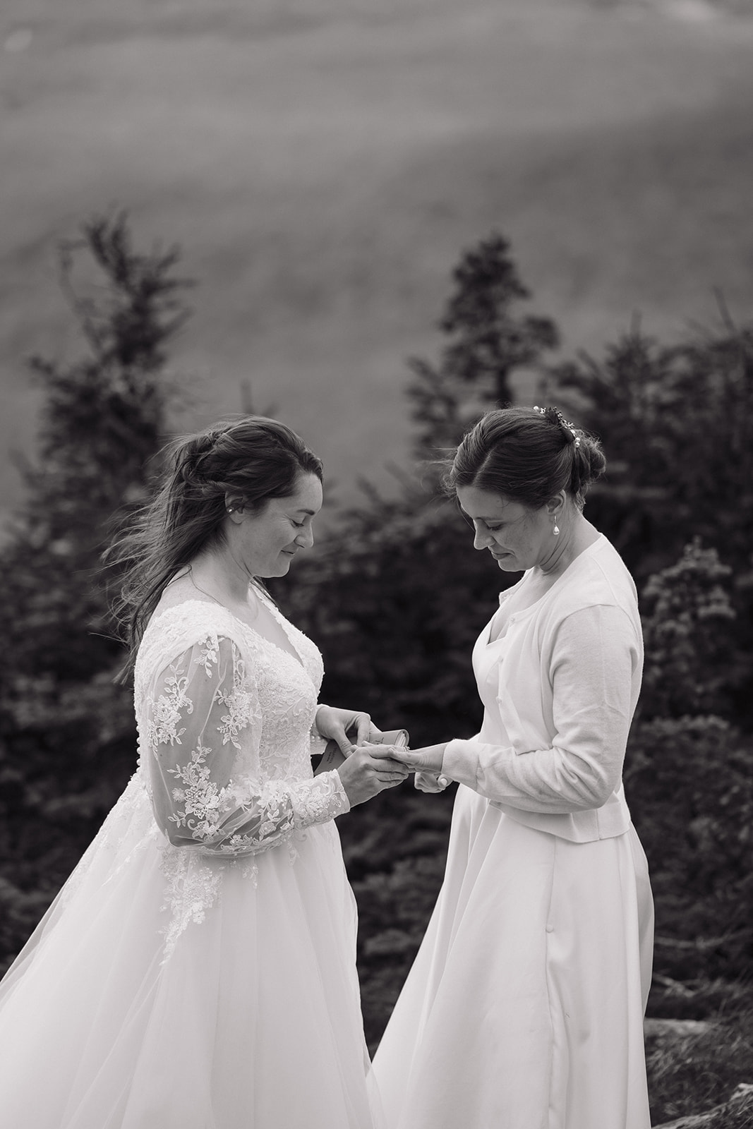 brides share an intimate moment on the top of the mountain during their wedding ceremony