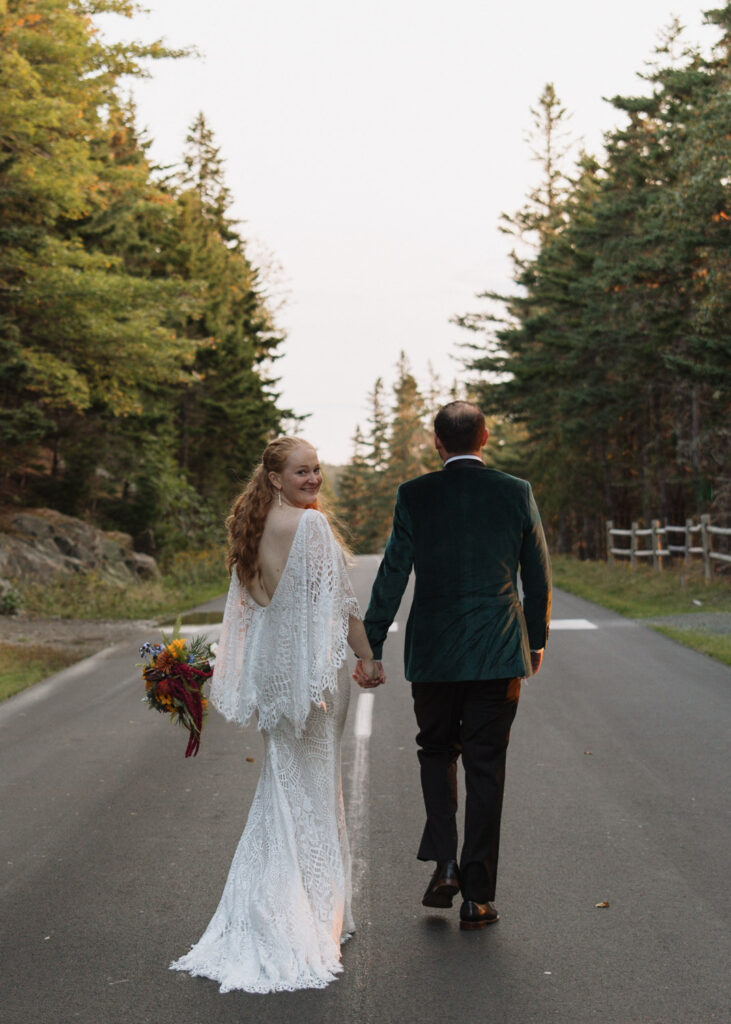 bride and groom walking Ocean Path Road in Acadia national park