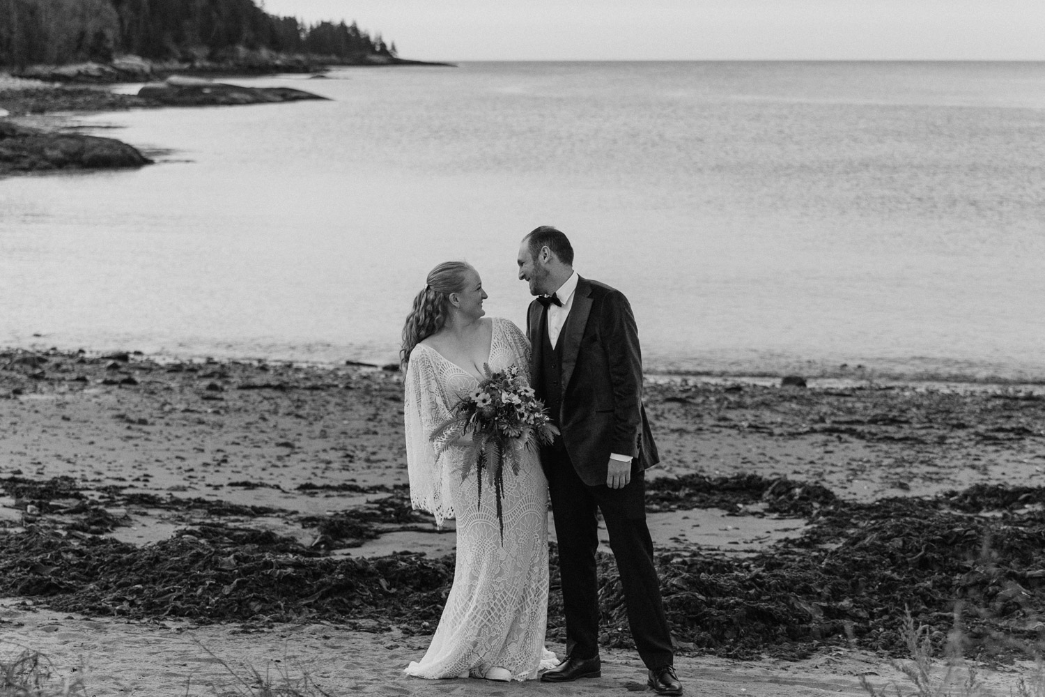 bride and groom pose on the beach in Acadia 
