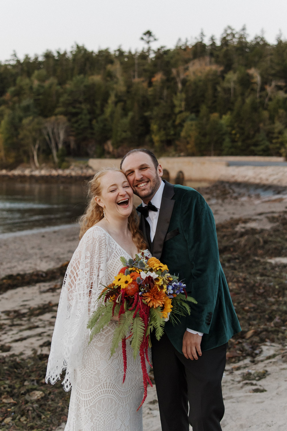 bride and groom pose on the beach in Acadia Maine
