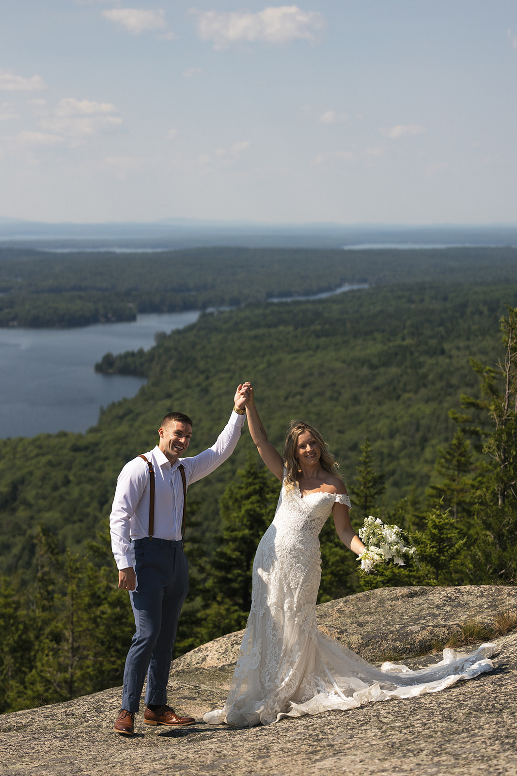Bride and Groom celebrating after saying private vows with a beautiful background in Acadia 
