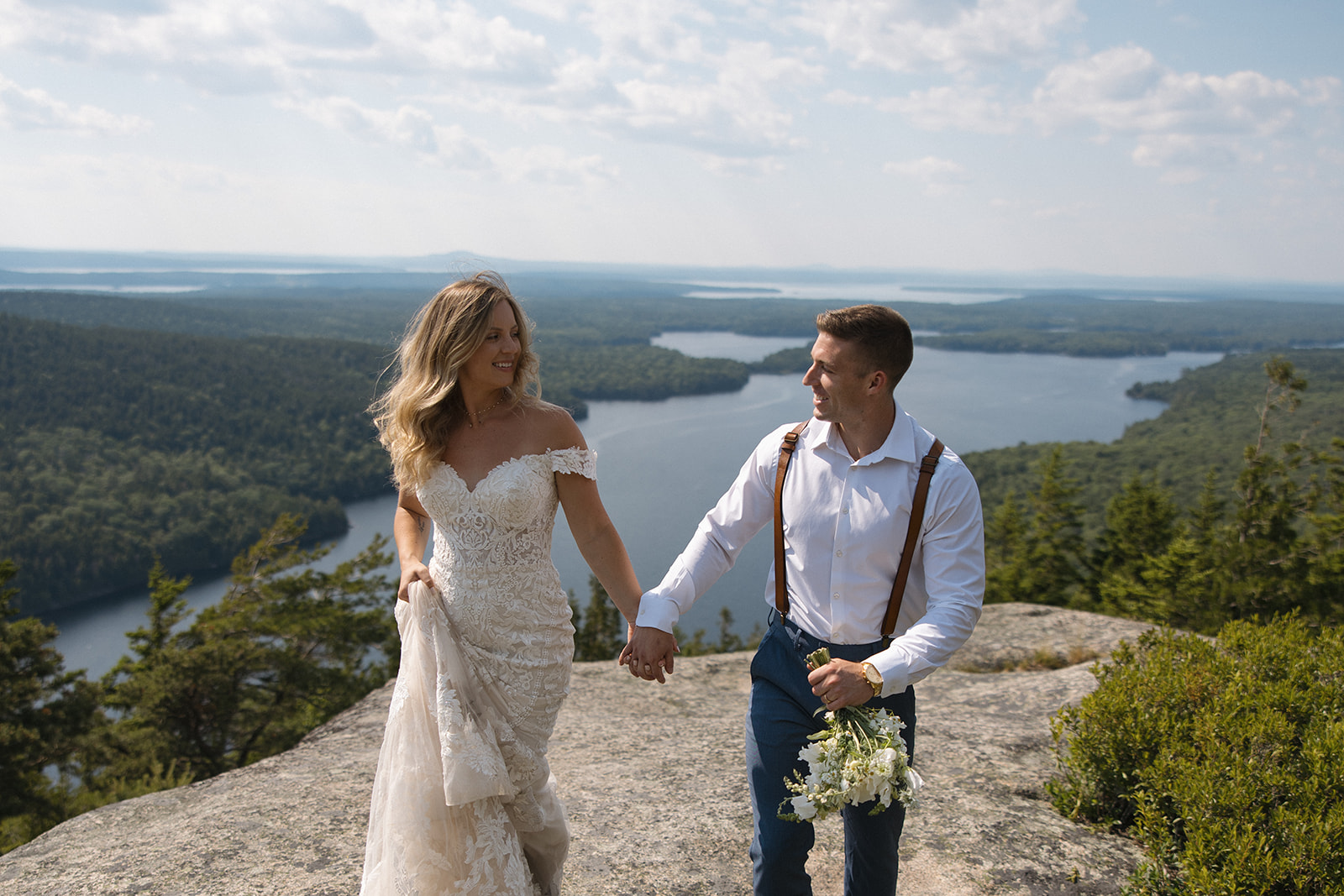Bride and Groom walking after saying vows with a beautiful background in Acadia 
