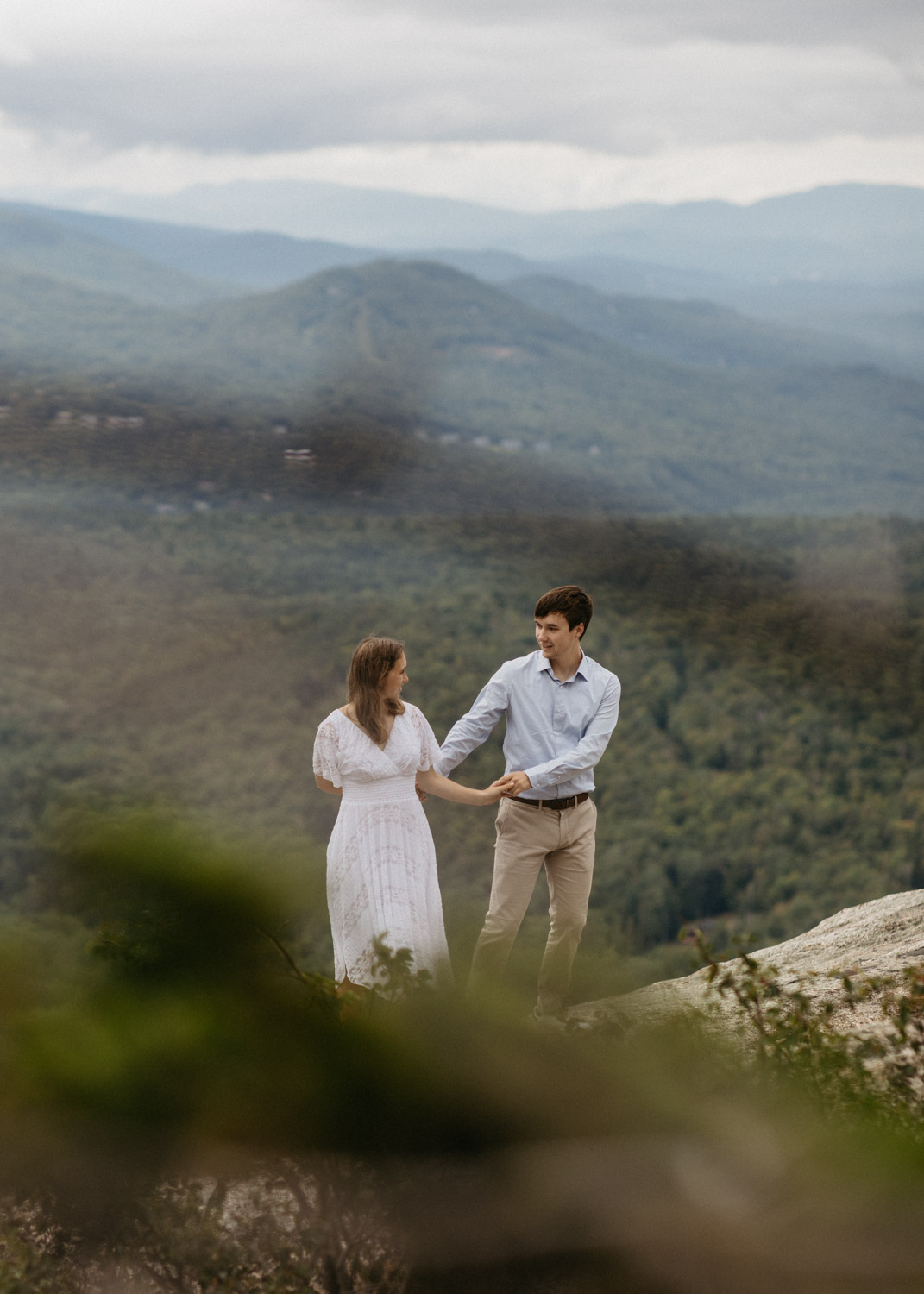 couple pose together with the stunning valley view in the background