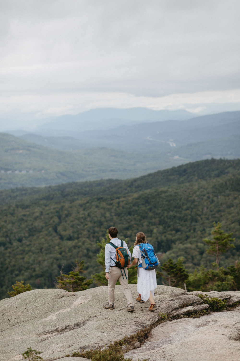 couple overlook the valleys during their White mountain hiking engagement photos