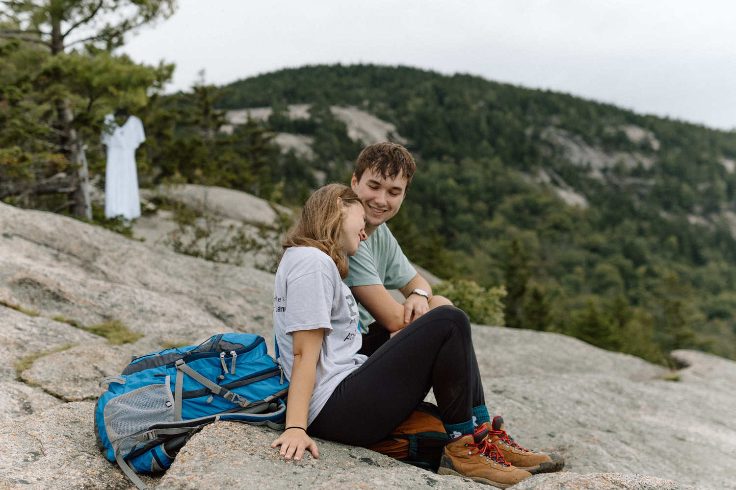 couple pose together on the cliffside during the White mountain engagement photoshoot