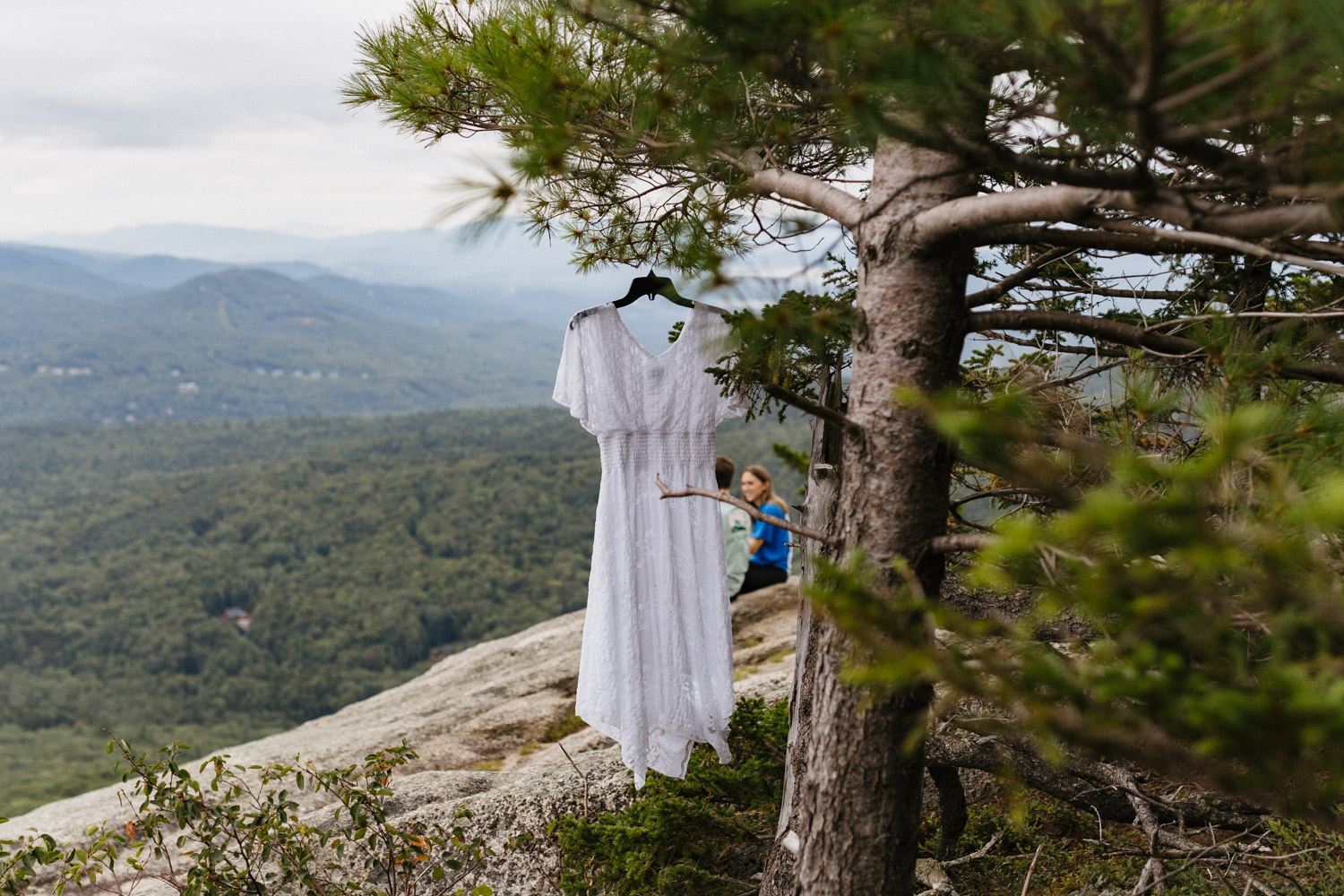 dress hangs over the White mountain engagement photoshoot