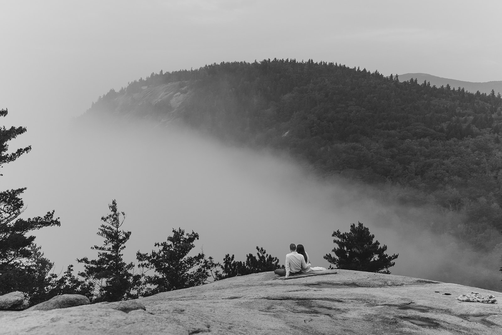 couple sit on a ledge during their NH elopement