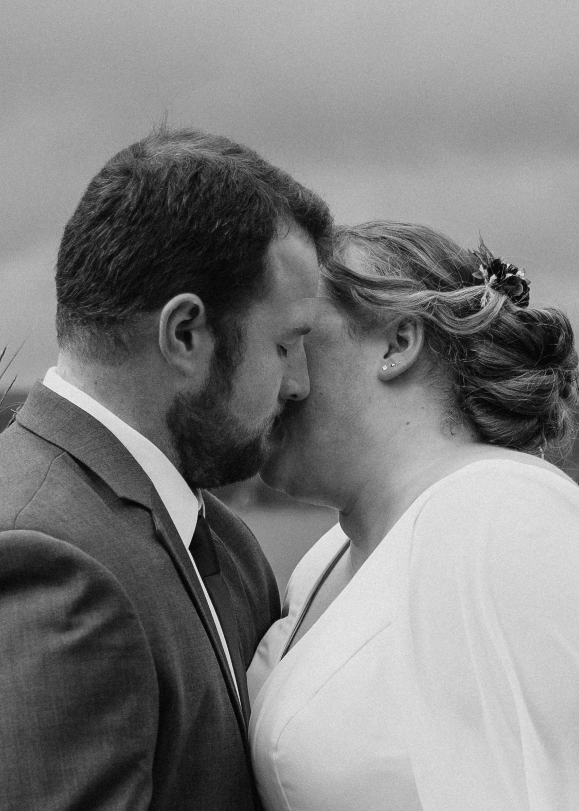 bride and groom share an emotional first look photo session on a lake dock