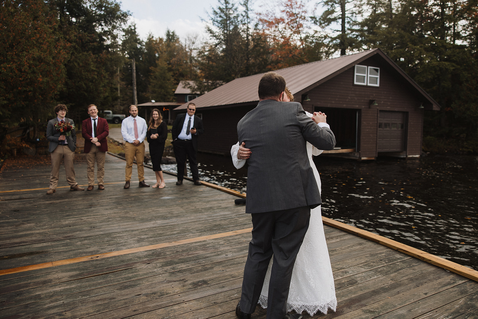 bride and groom exit their dreamy lake dock elopement ceremony