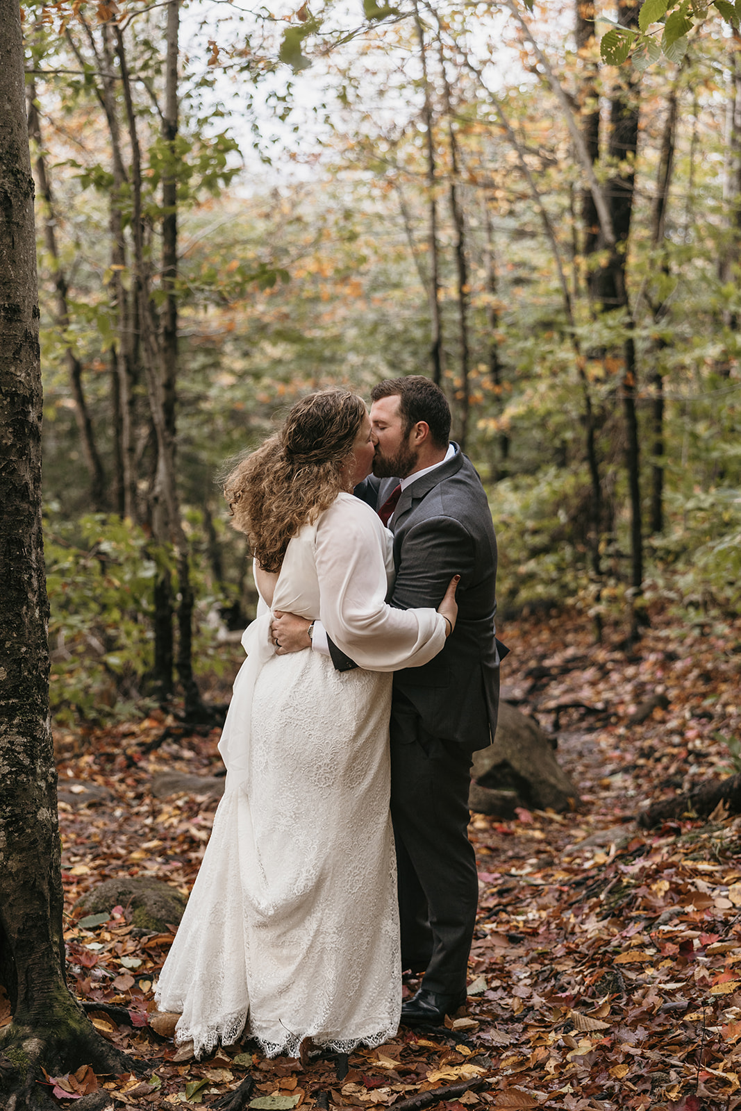 bride and groom hike through the Autumn foliage in upstate New York