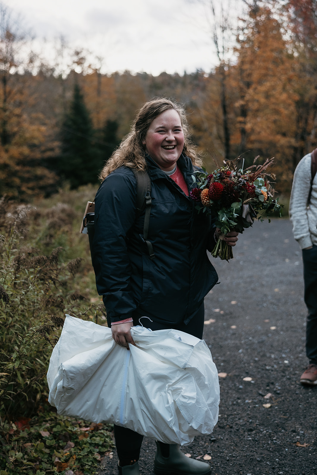 bride and groom hike through the Autumn foliage in upstate New York