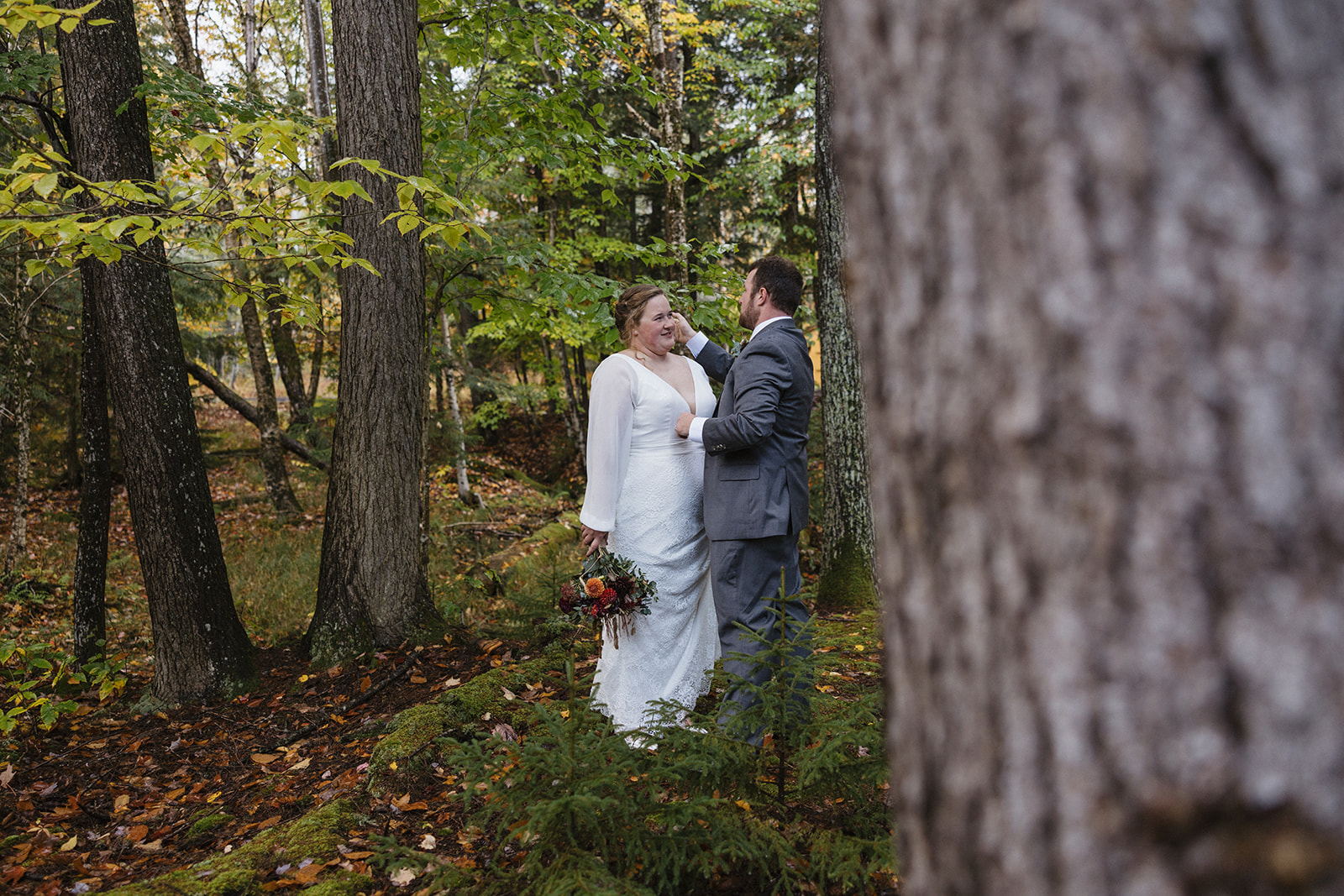 bride and groom hike through the Autumn foliage in upstate New York