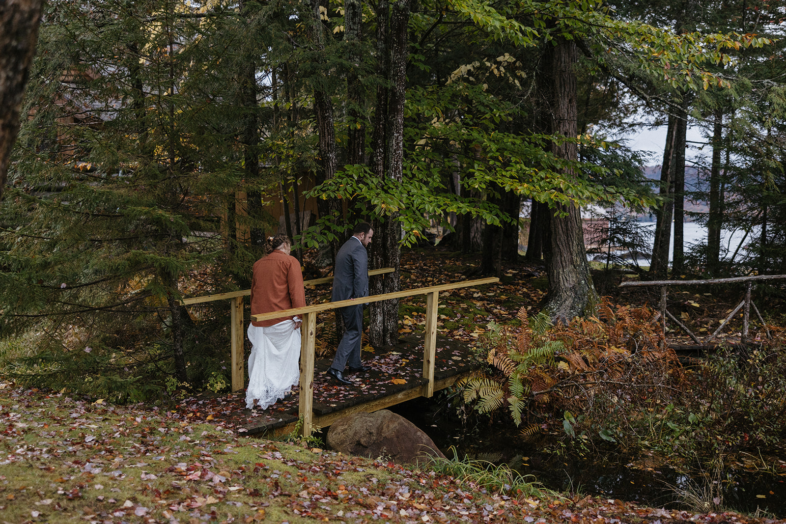 bride and groom hike through the Autumn foliage in upstate New York