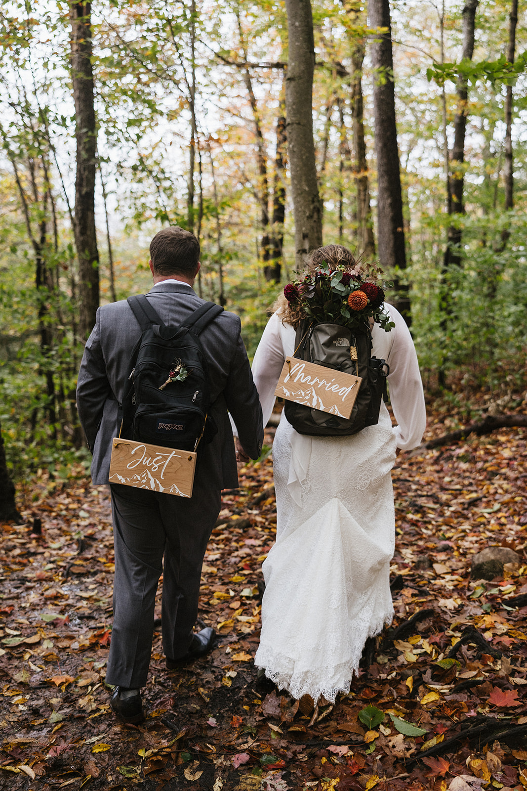 bride and groom hike through the Autumn foliage in upstate New York