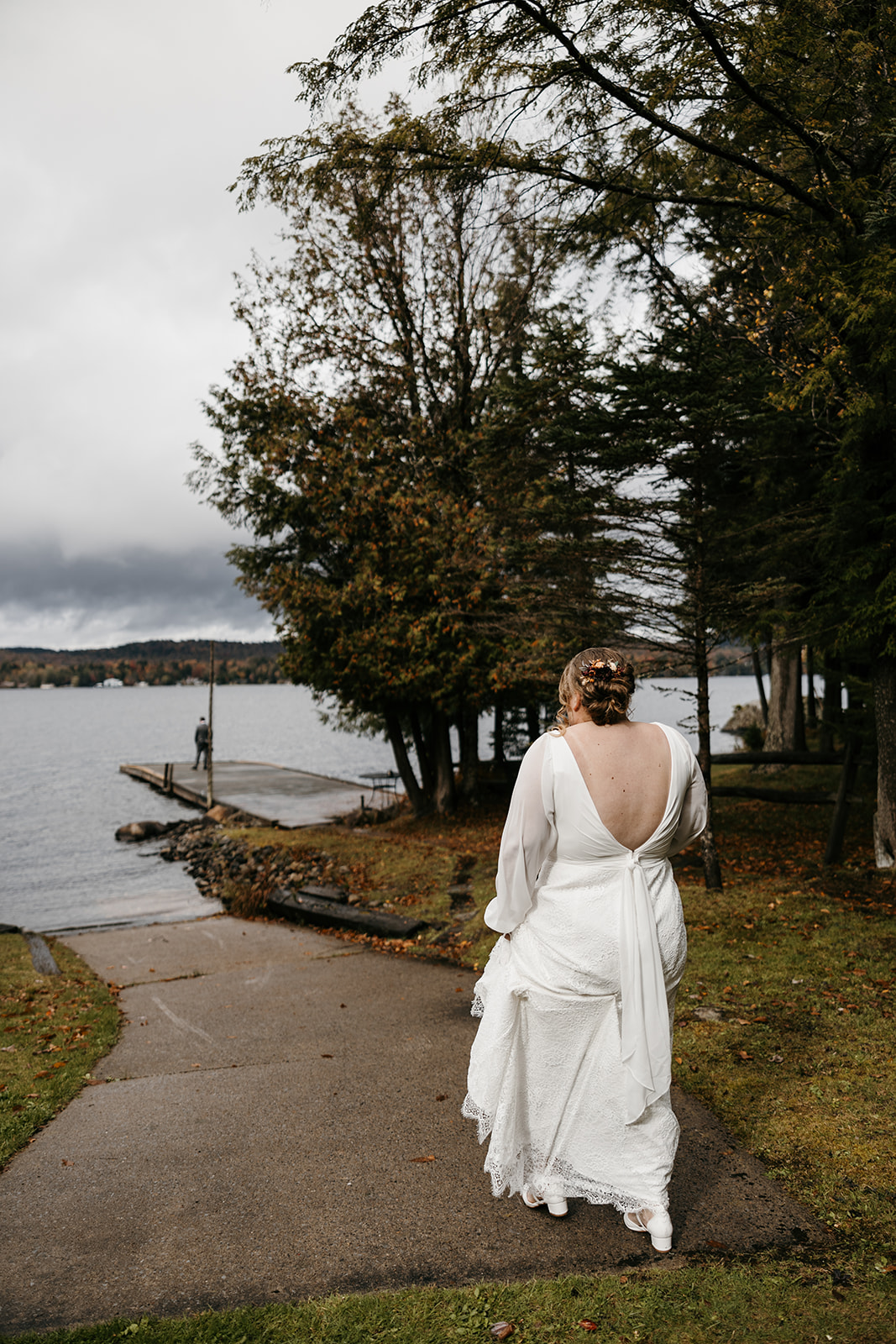 bride walks towards the docks for their emotional first look photoshoot