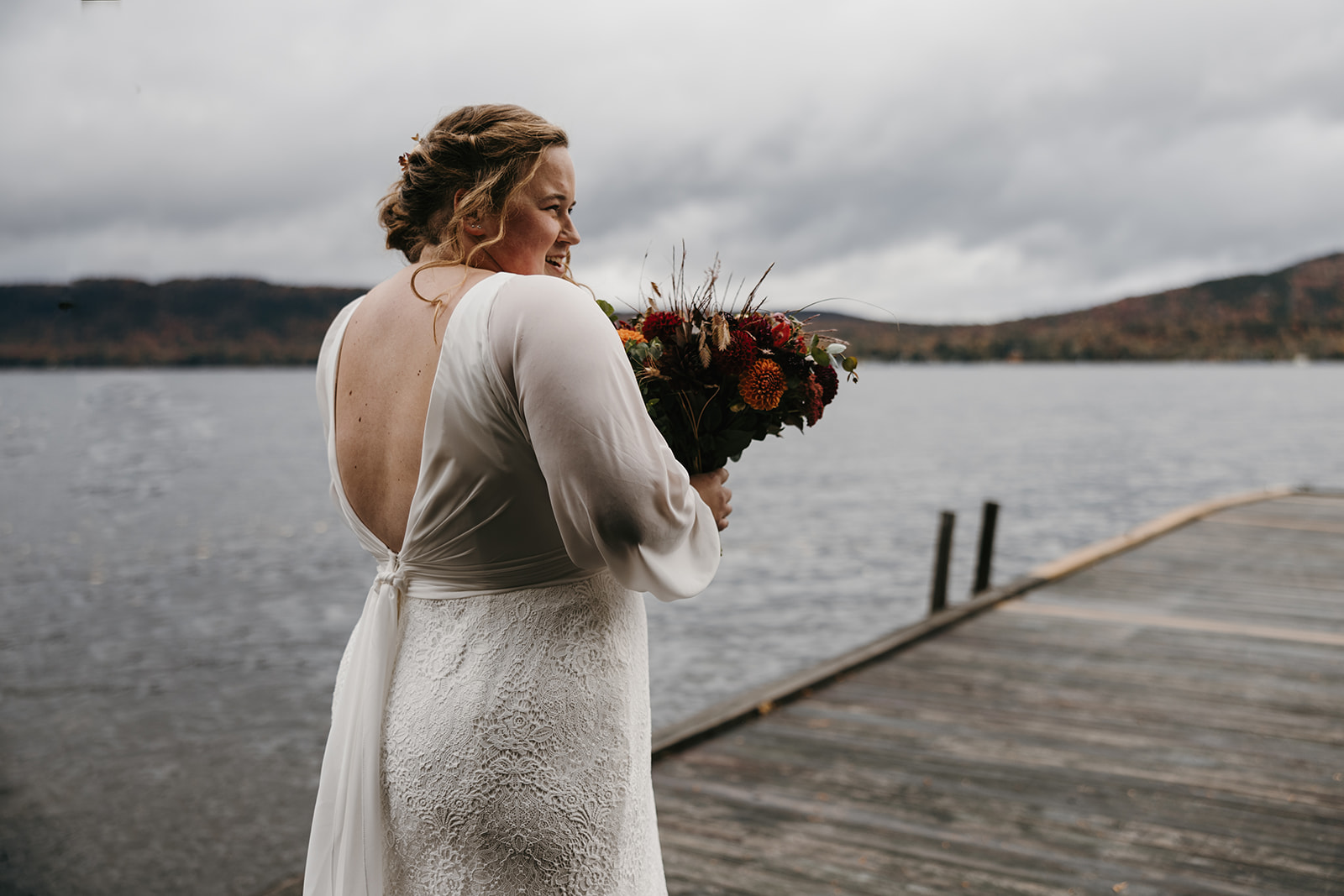 bride walks towards the docks for their emotional first look photoshoot