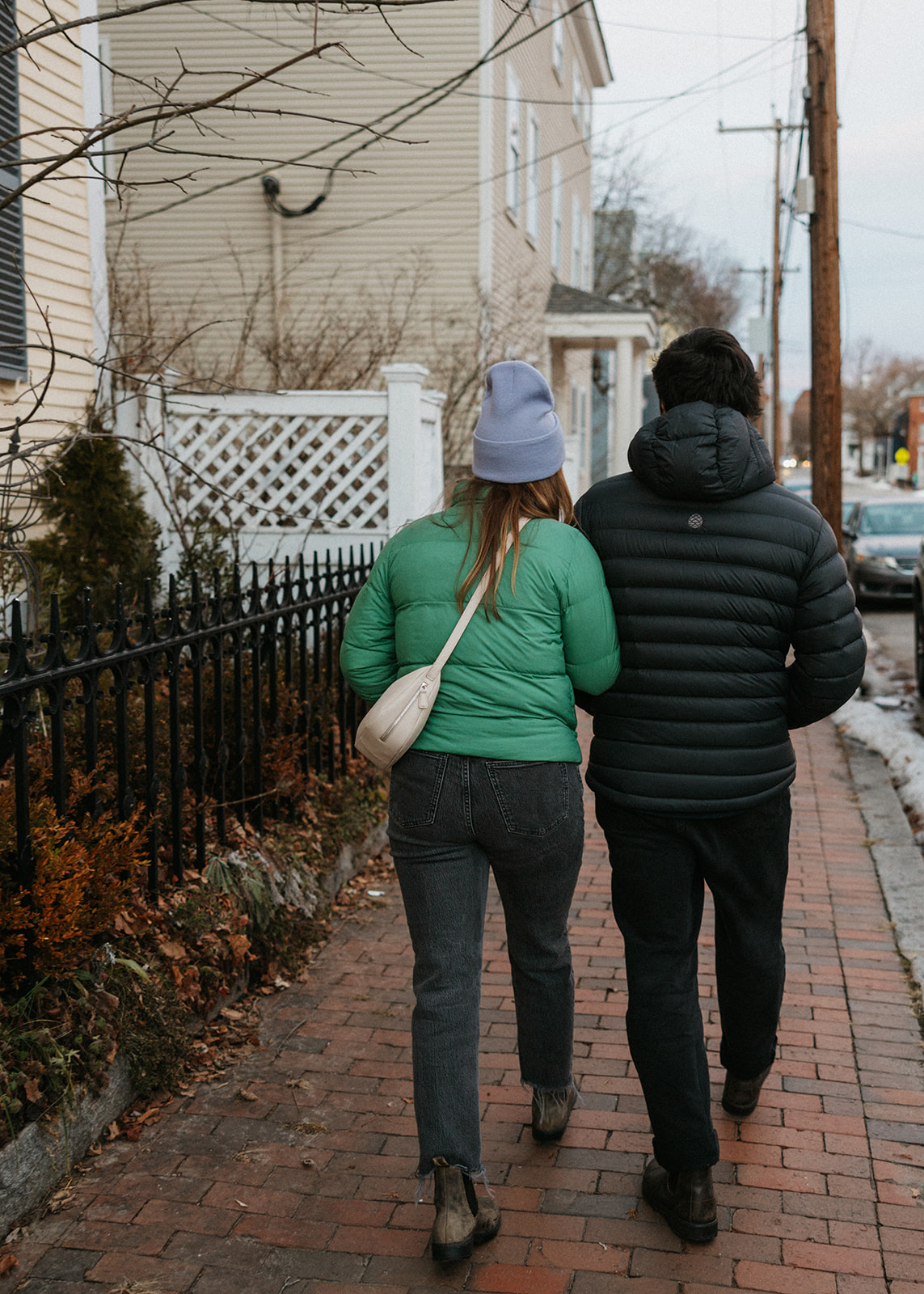 stunning couple pose outside their stunning New Hampshire home