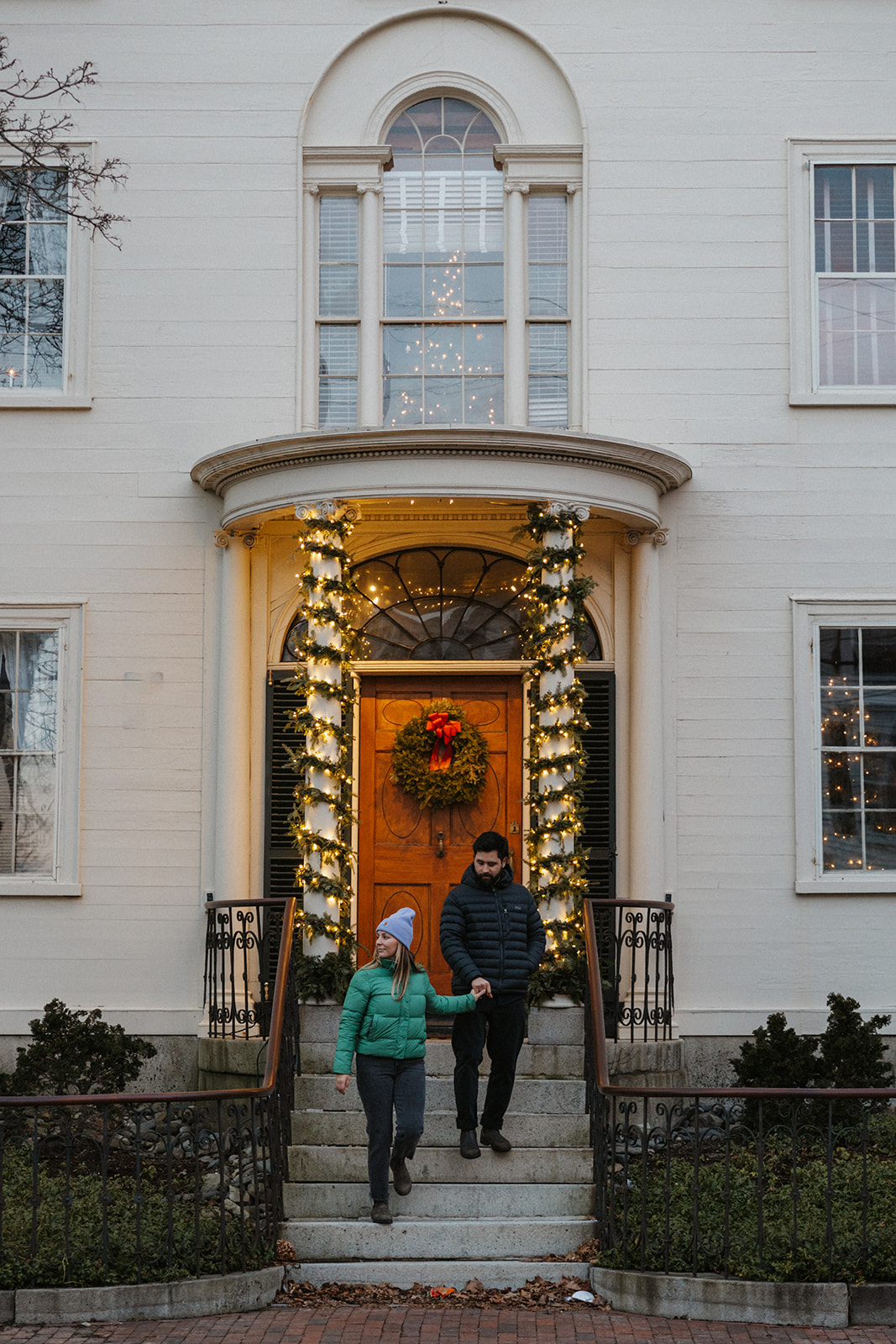 stunning couple pose outside their stunning New Hampshire home