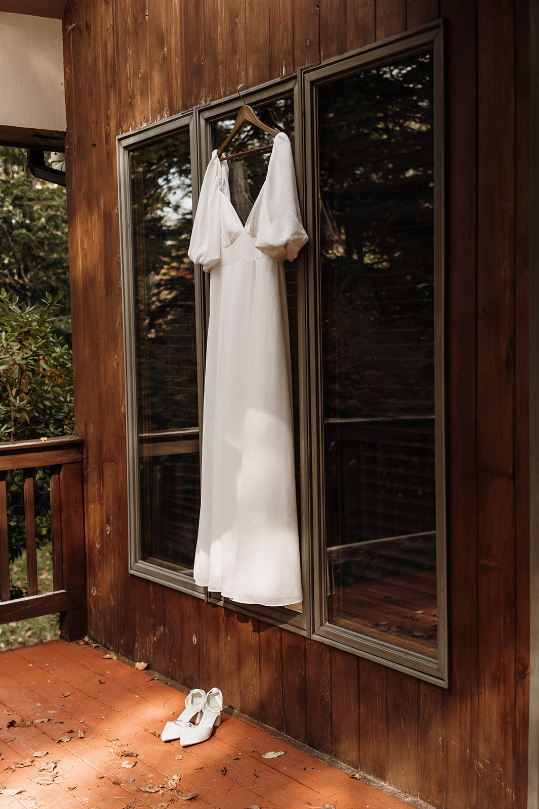 brides wedding dress hangs before her stunning Echo lake elopement