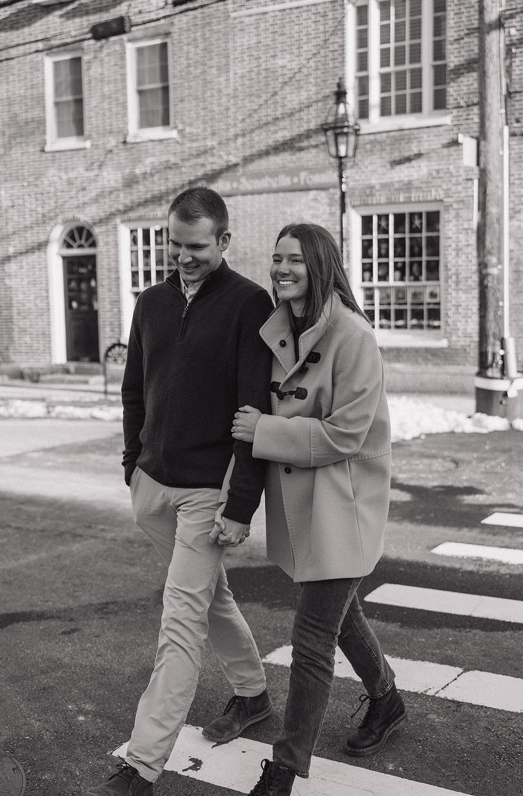 beautiful couple walk on the Seacoast town streets