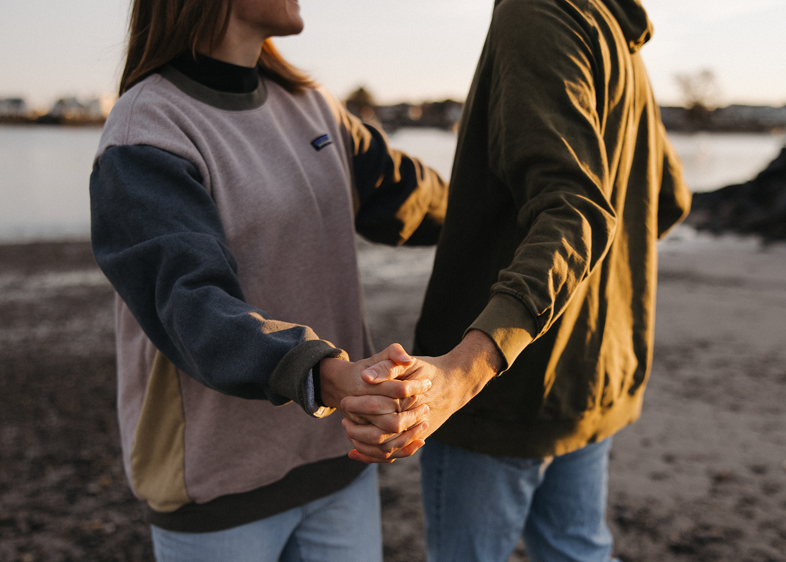 stunning couple pose on a New Hampshire beach during their East coast engagement photos