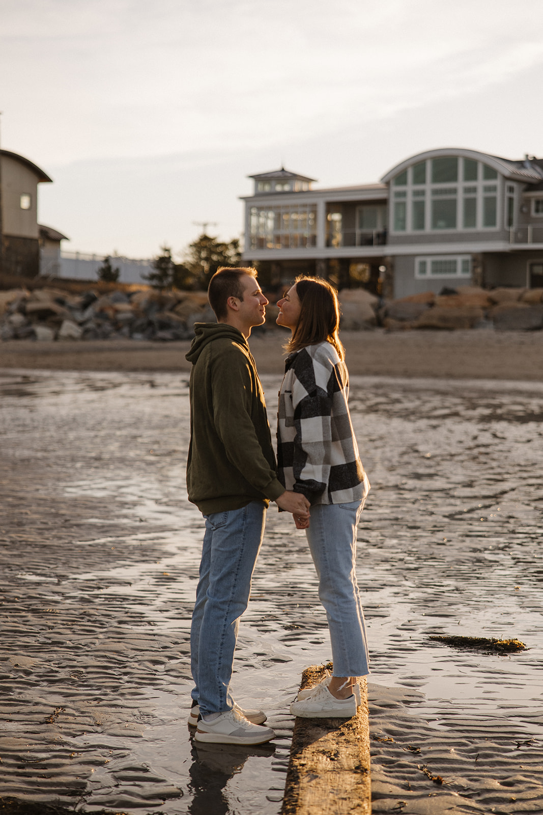 beautiful couple pose on an East Coast beach during their engagement photoshoot