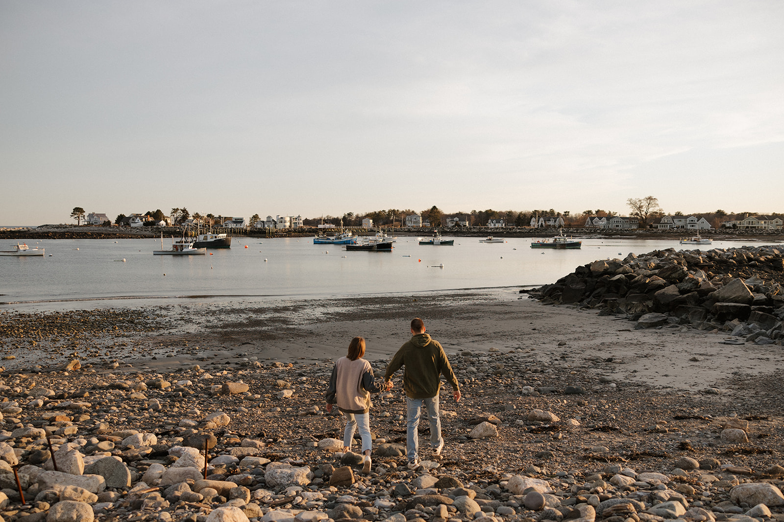 beautiful couple pose on an East Coast beach during their engagement photoshoot