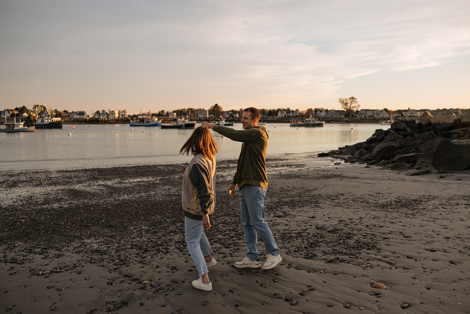 beautiful couple pose on an East Coast beach during their engagement photoshoot