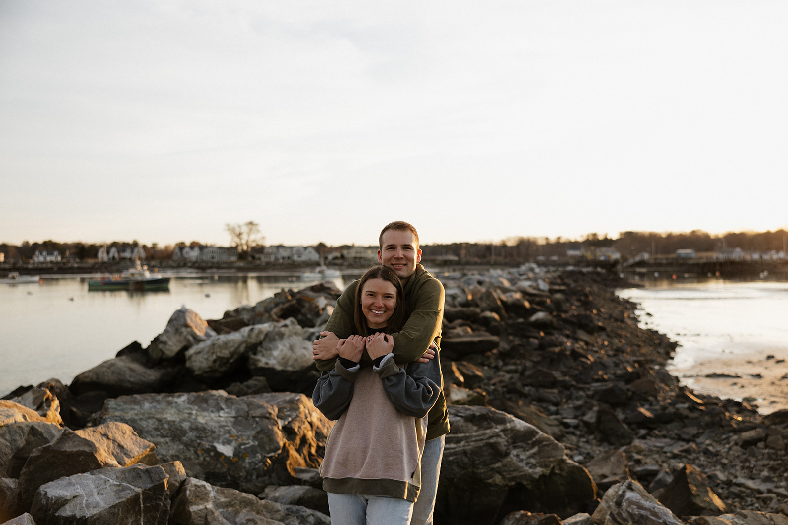 beautiful couple pose on an East Coast beach during their engagement photoshoot