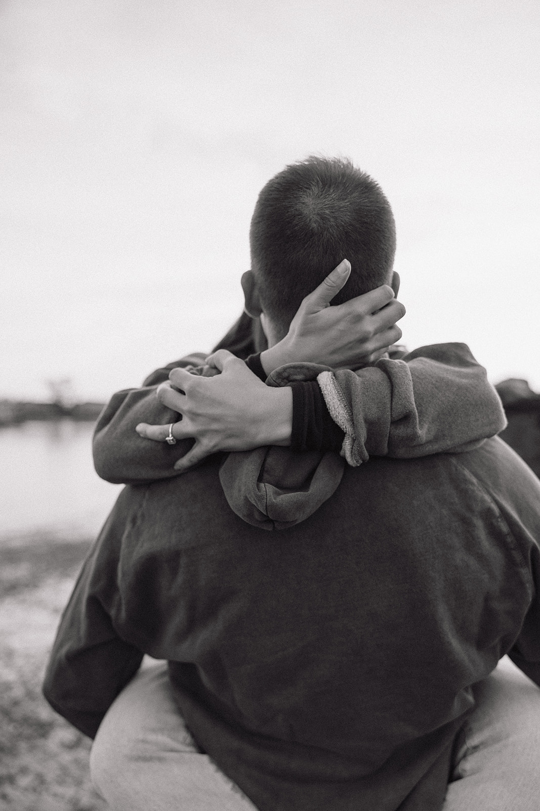 stunning couple pose on a New Hampshire beach during their East coast engagement photos