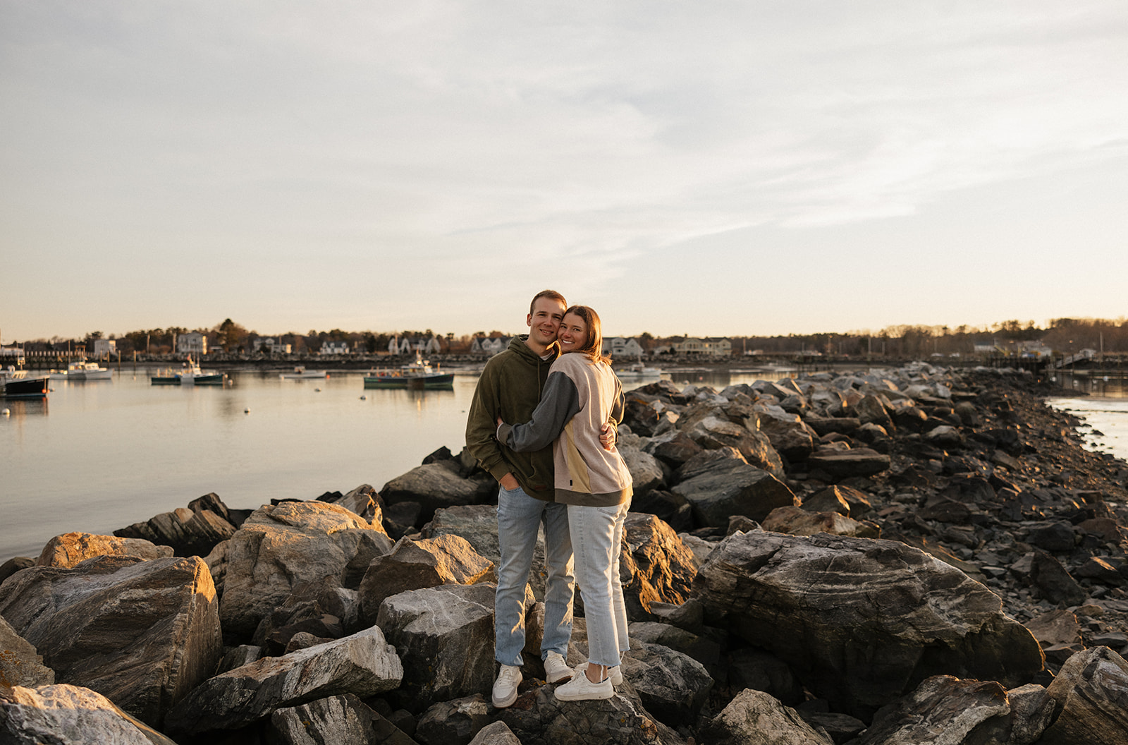 stunning couple pose on a New Hampshire beach during their East coast engagement photos