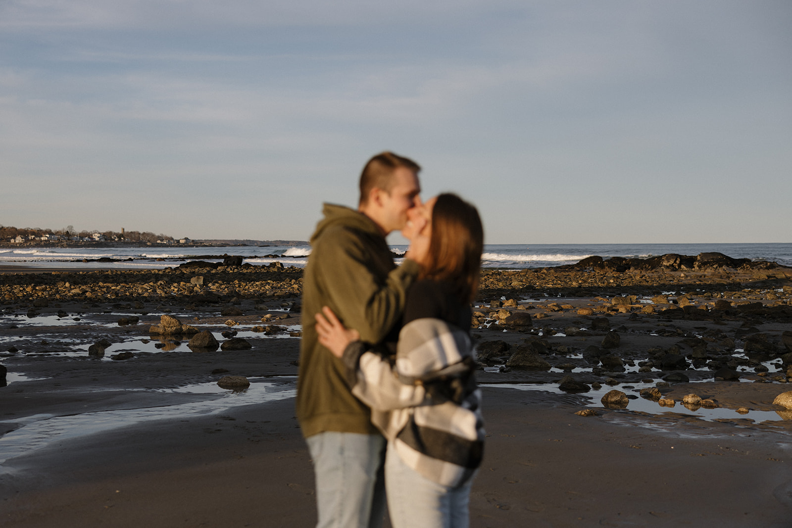 beautiful couple pose on an East Coast beach during their engagement photoshoot