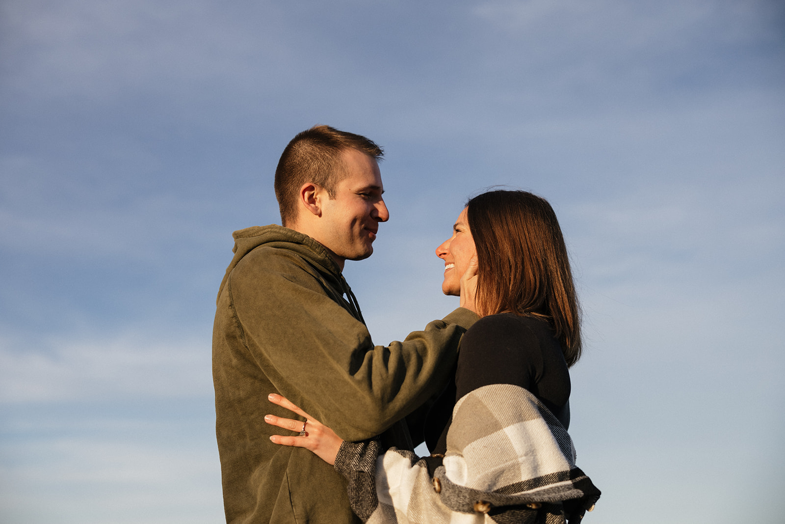 beautiful couple pose on an East Coast beach during their engagement photoshoot