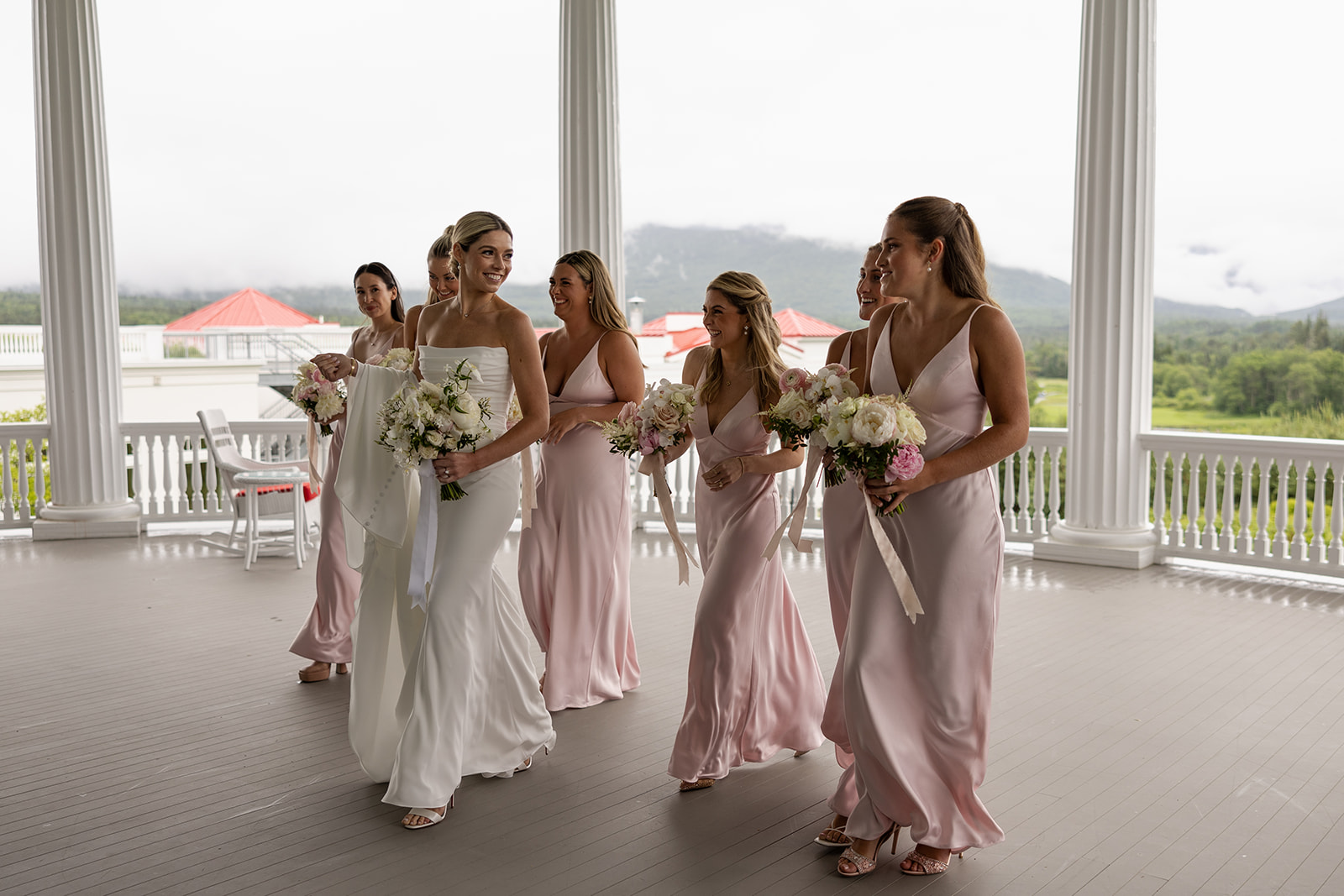 wedding party poses together after a rainy wedding day