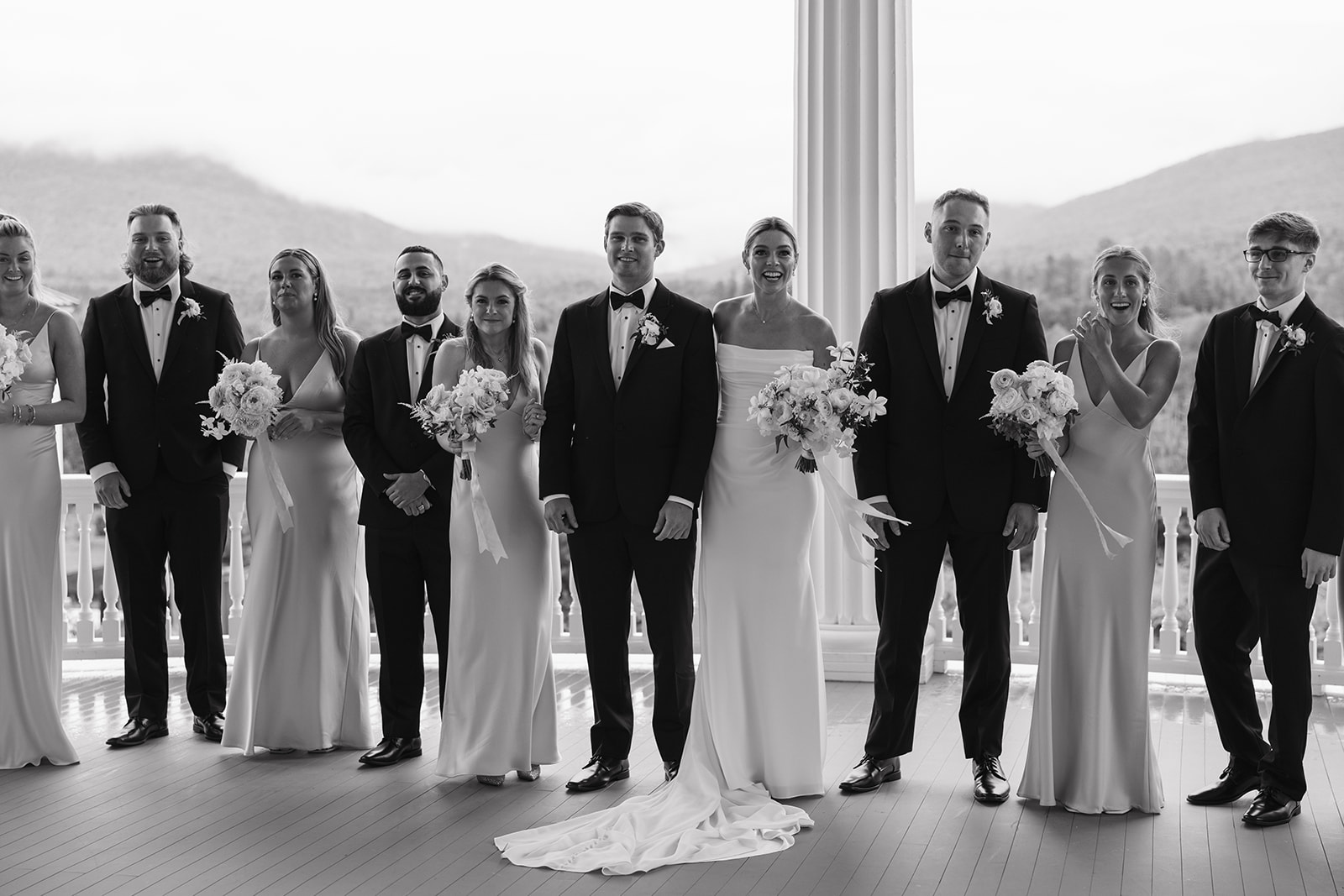 wedding party poses together after a rainy wedding day