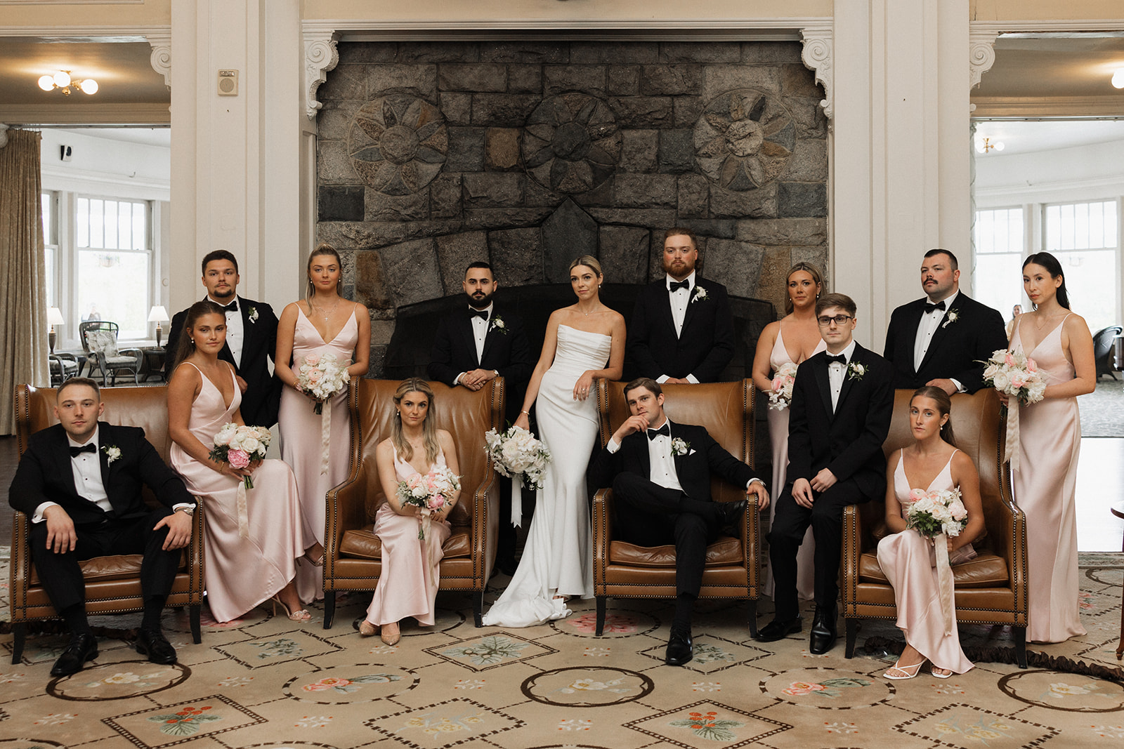 wedding party poses together after a rainy wedding day