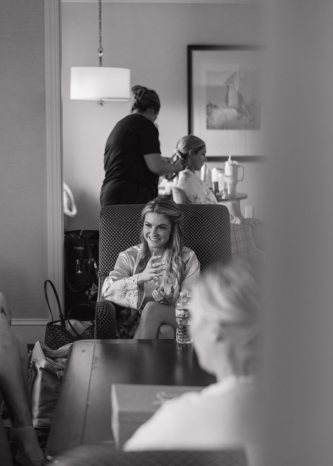 bride gets help preparing for her stunning wedding day