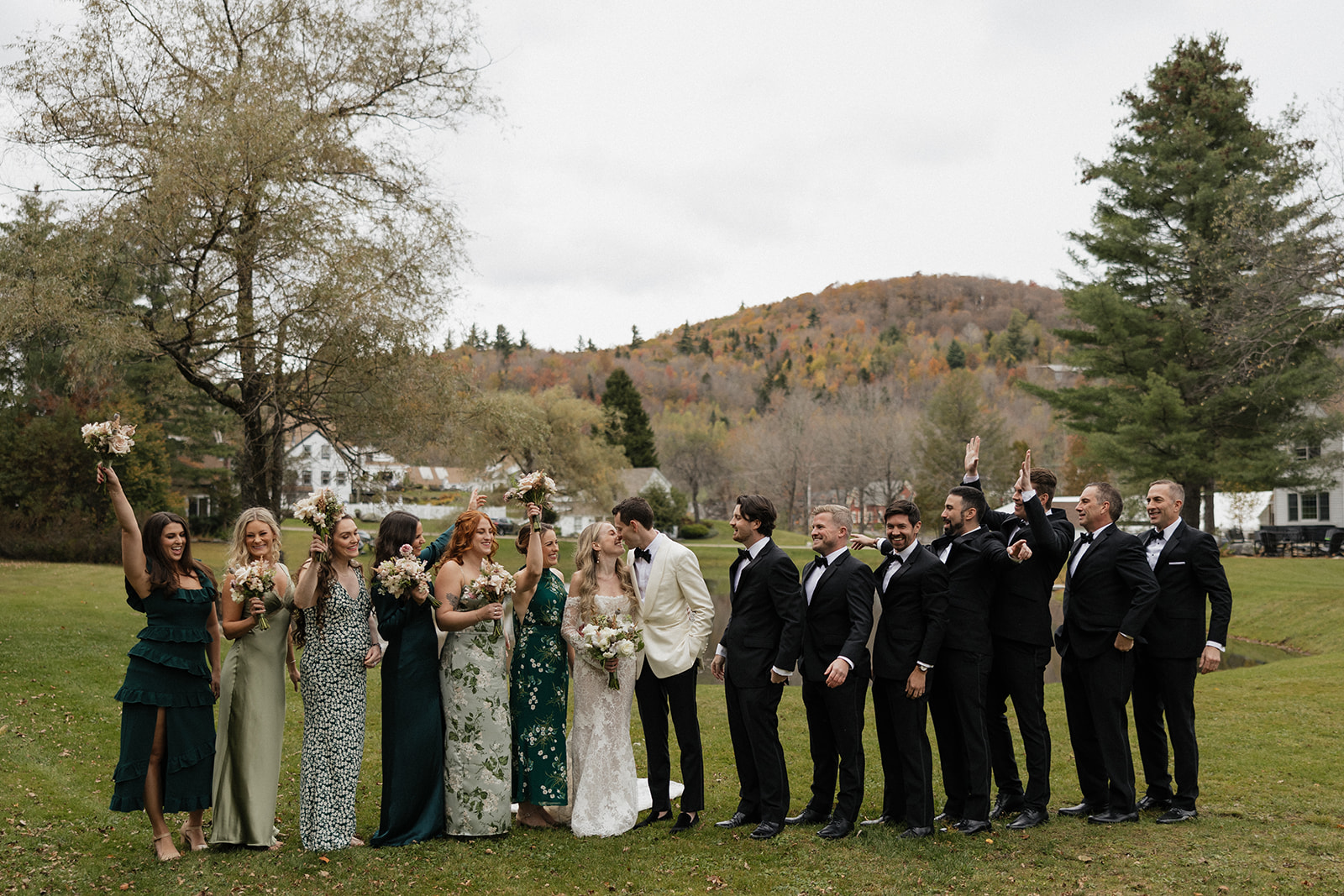 wedding party poses for a photo outside their vermont wedding day