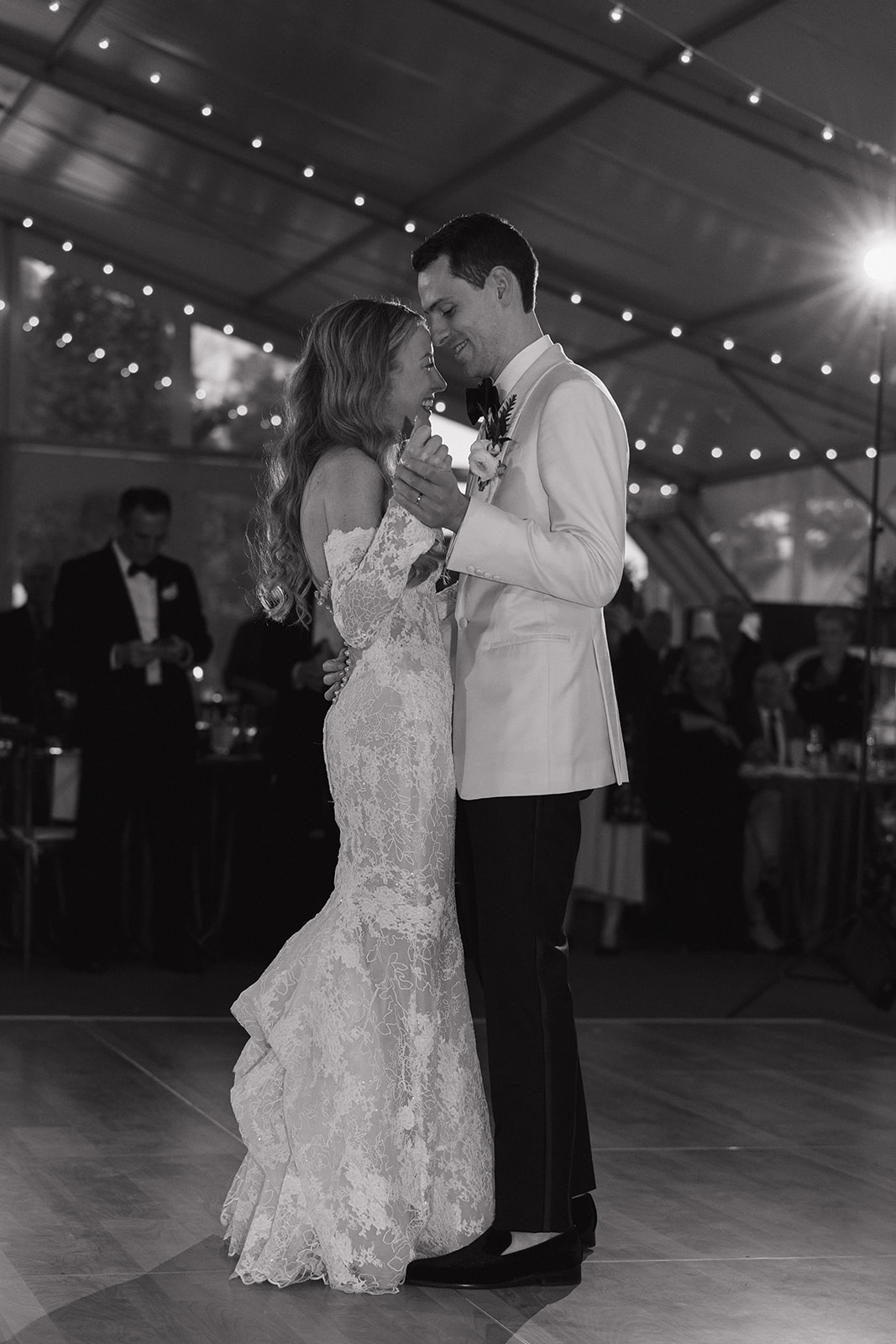 bride and groom share their first dance together