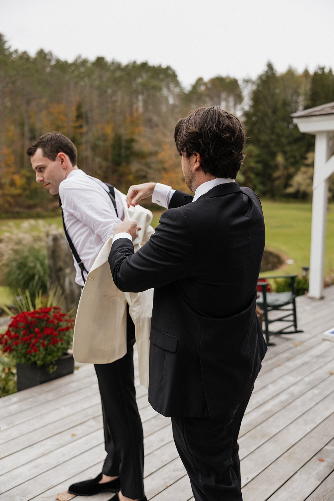 groom gets help finalizing his wedding preparations