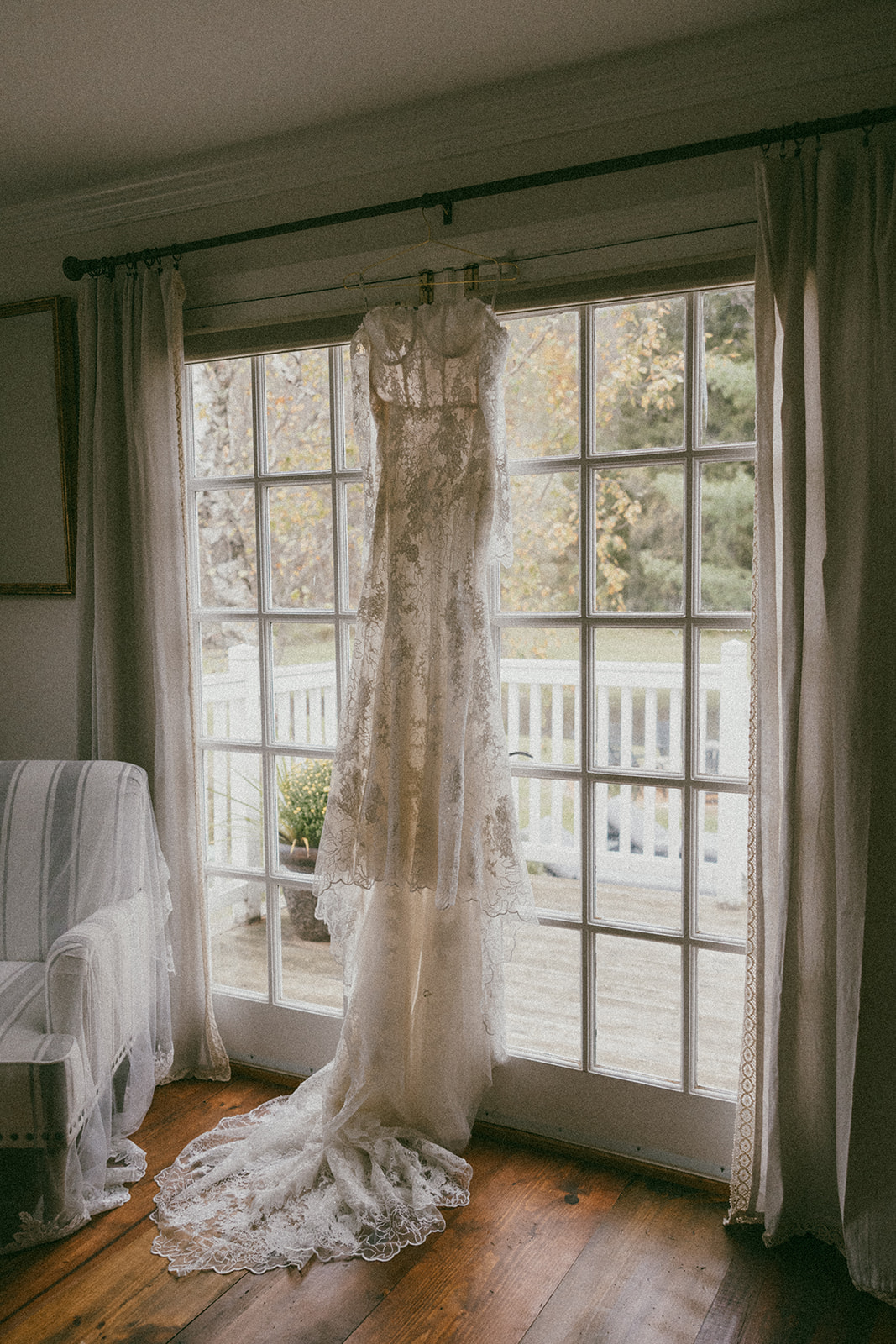 brides dress hangs ready for her stunning Vermont wedding day