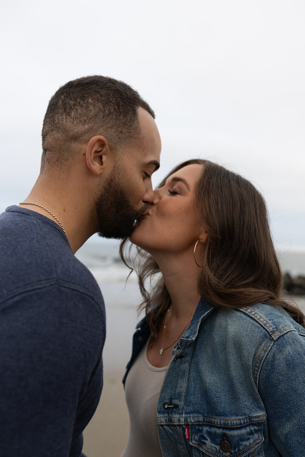 beautiful couple pose together on the beach